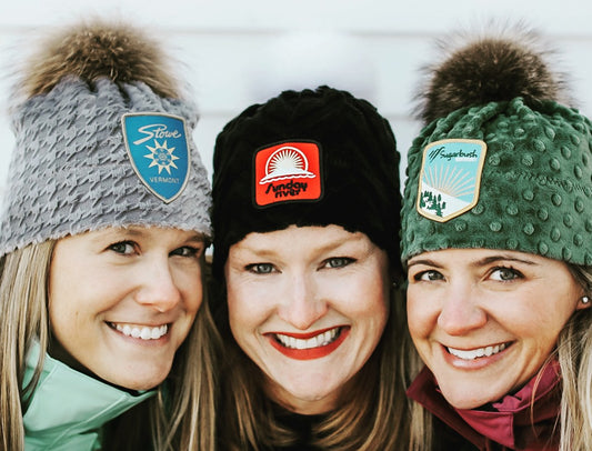 Three women wearing Vintage Ski resort patch beanies Sugarbush VT, Stowe Mountain VT, Sunday River ME